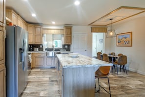 A modern kitchen with a central island, stainless steel appliances, and wooden cabinetry. - 1 Mi to Dtwn Driggs! Secluded Escape w/ Yard (Driggs)