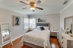 A bedroom with a bed, nightstands, a dresser, a ceiling fan, and artwork on the walls. - Walk to Metro! Historic View Park Home w/ Patio (Los Angeles)