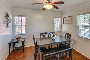 A dining room with a table, chairs, a bench, a ceiling fan, and windows with blinds. - Walk to Metro! Historic View Park Home w/ Patio (Los Angeles)