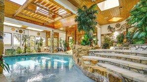 A swimming pool with stone steps leading up to a wooden deck, surrounded by various plants and decorative elements. - Family Retreat Ready! 'castlewood Ranch' in Chico (Chico)