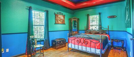 A room with a bed, a chest of drawers, a chair, and a window.