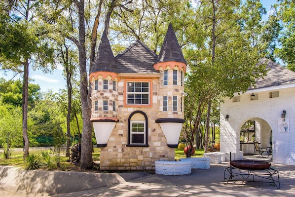 A stone castle-like structure with a central tower, a small window, and a door. - Family Retreat Ready! 'castlewood Ranch' in Chico (Chico)