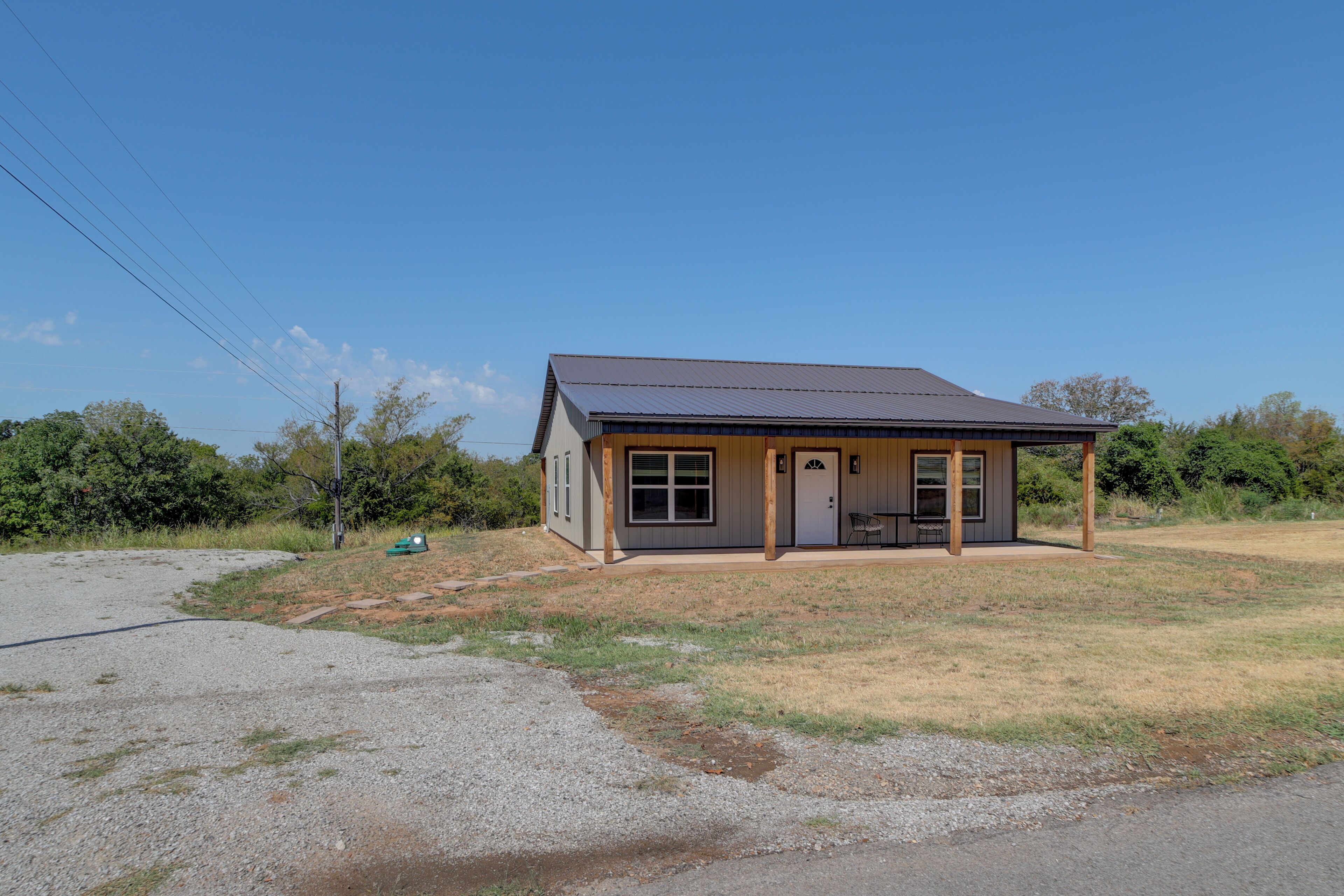 A small, single-story building with a flat roof and a porch.