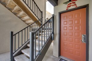 A wooden staircase with metal railings leading to a door with a square pattern. - 'above the Lake Escape' Condo in Lake Ozark (Lake Ozark)