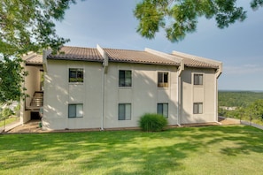 A two-story building with a tiled roof, multiple windows, and a small front porch. - 'above the Lake Escape' Condo in Lake Ozark (Lake Ozark)