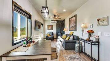 A spacious living area with a dining table, a sofa, and a fireplace.