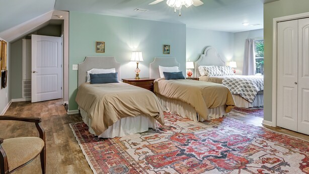 A bedroom with two beds, a ceiling fan, and a patterned rug. - Private Woodland Garden Retreat in Ethelsville (Ethelsville)