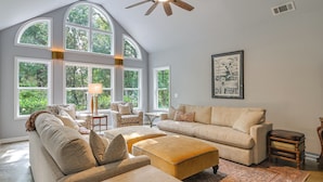 A spacious living room with a high ceiling, large windows, and a ceiling fan. - Private Woodland Garden Retreat in Ethelsville (Ethelsville)