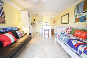 A compact hotel room with a bed, a sofa, a small kitchen area, and a dining table. - 4201 Coastal Highway Unit 404 (Ocean City)