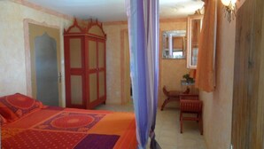 A bedroom with a bed, a wardrobe, a chair, and a window. - Holiday Home 'Maison Cazac Marrakech' with Mountain View and Wi-Fi (Cazac)