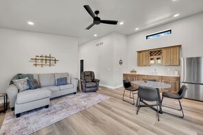 A modern living room with a sofa, armchairs, and a dining table. - Experience the vibe of Hill City, South Dakota (Hill  City)