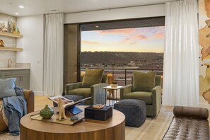A modern living room with a view of a cityscape and hills. - Red Rock Isle 7 Bedroom Townhouse (Washington)