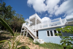 A two-story building with a white exterior and a blue lower section.