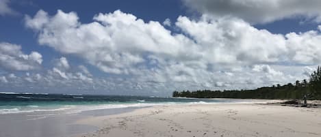 A beach with a clear sky and ocean waves.