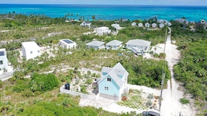 A coastal residential area with houses, a beach, and a clear view of the ocean. - Eagle Ray - Brand New Beach Cottage W/views, Walk To Restaurant/ 2 Bedroom Home (North Palmetto Point)