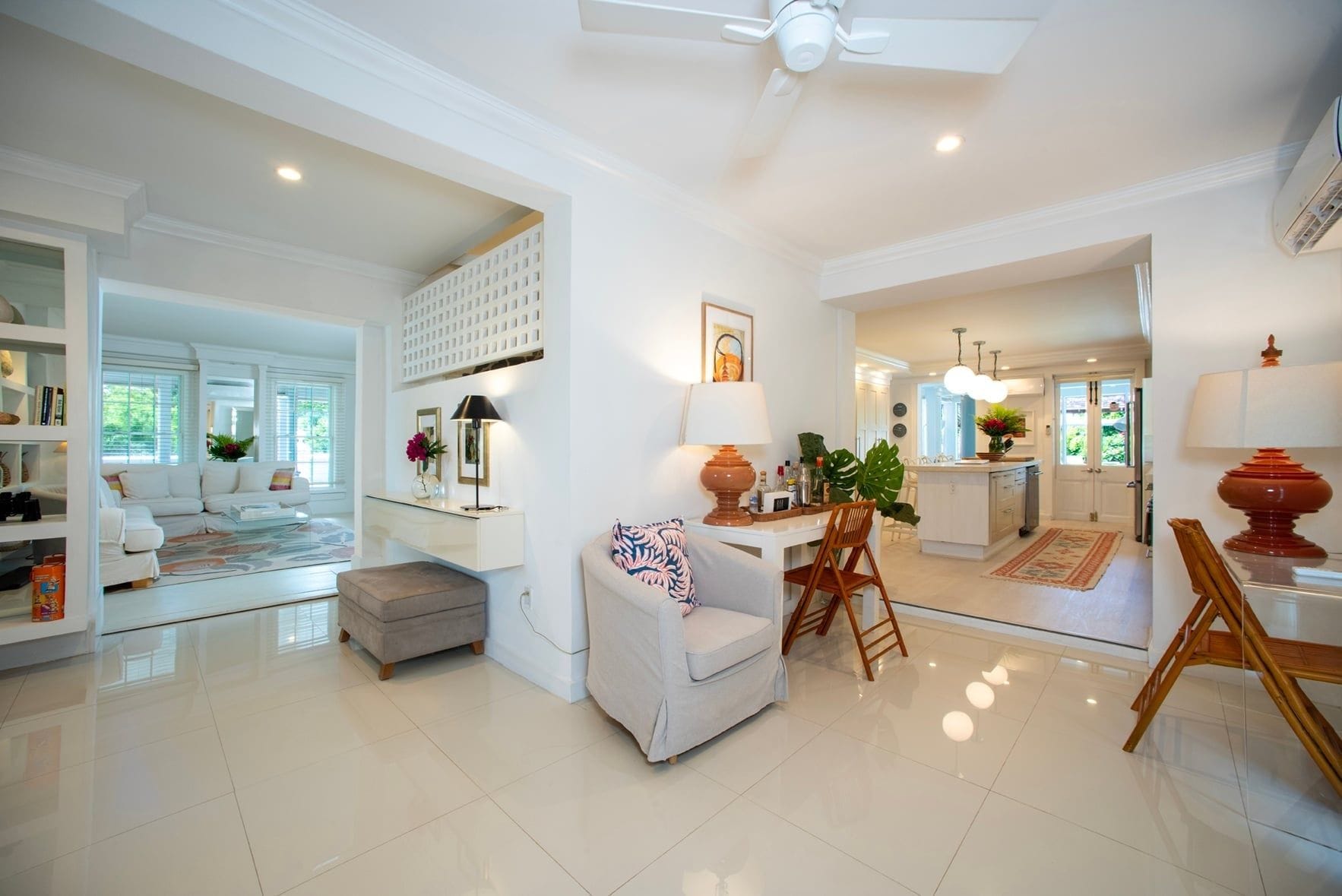 A spacious living area with a sofa, coffee table, and a dining area with chairs and a table.