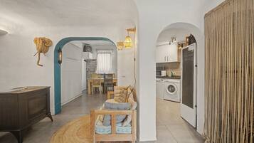 A modern interior with a dining area, kitchen, and laundry room.