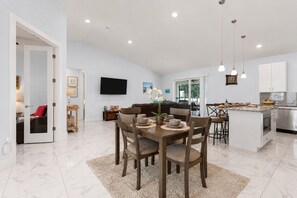 A modern kitchen with a marble countertop, a built-in oven, and a stainless steel sink. - Cape Coral home with Pool, Spa & Game Room (Cape Coral)