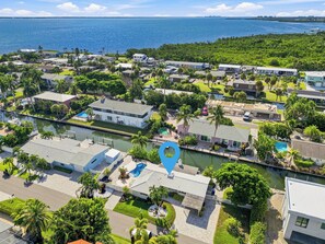 A coastal residential area with houses, a marina, and a large body of water.