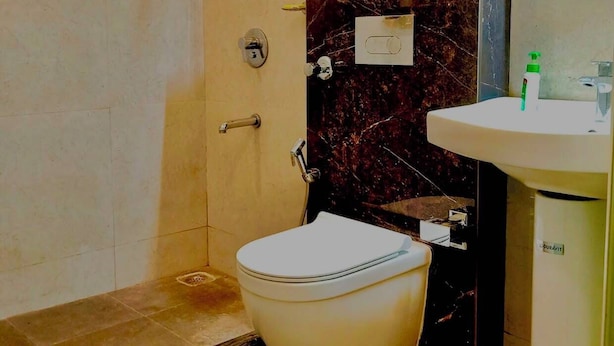 Ein Badezimmer mit Dusche, Toilette und Waschbecken.