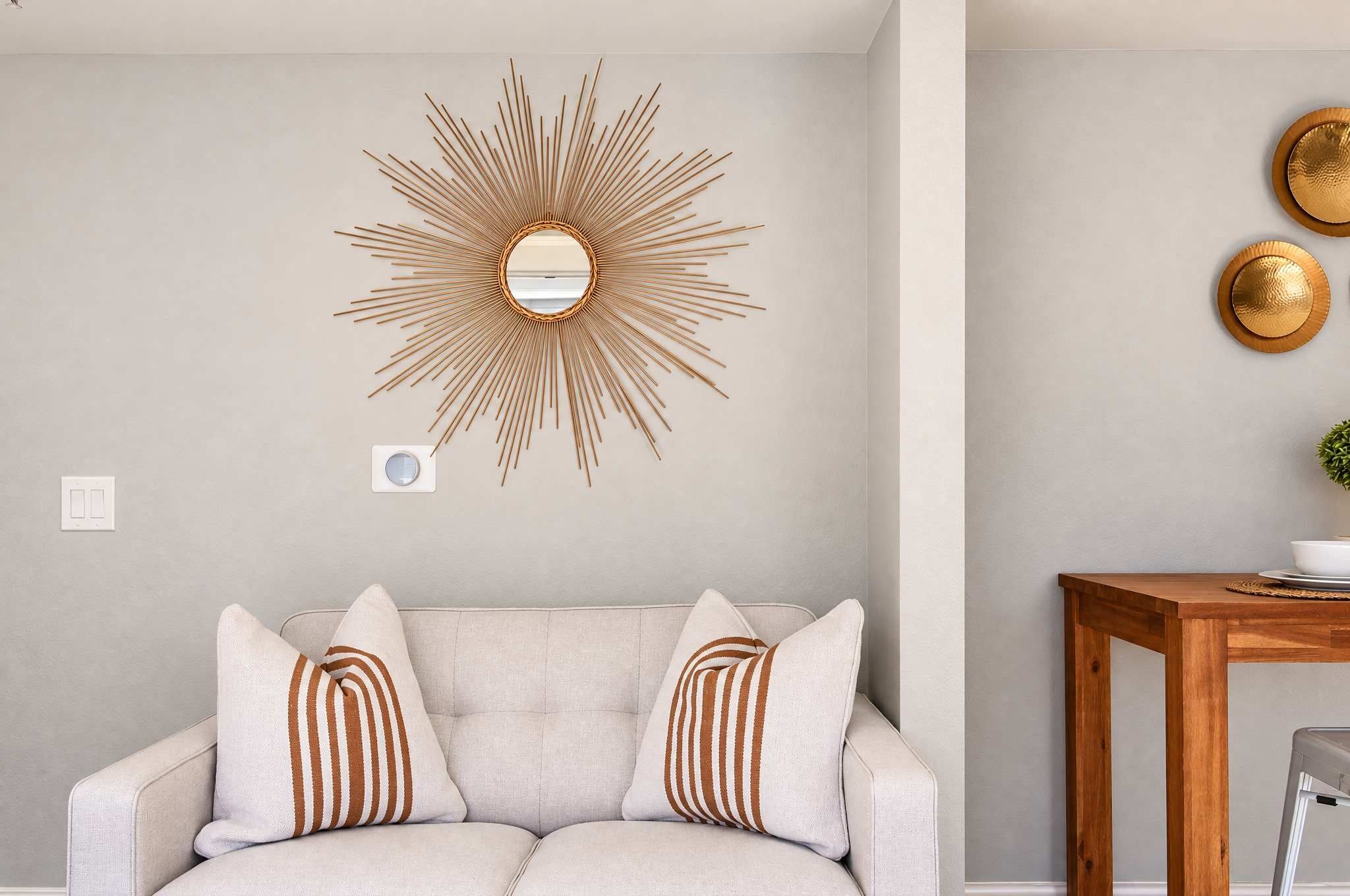 🛋️ Chic lounge nook with sunburst wall decor — a cozy, stylish corner to read, relax, or unwind after exploring the city.