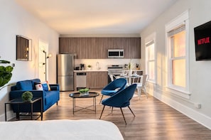 Un apartamento moderno con sala de estar, cocina y comedor.