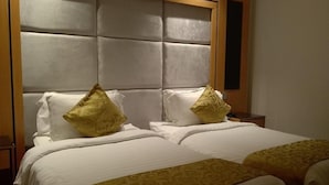 A hotel room with a large bed, two pillows, and a headboard. - Al Rayyan Tower (Jeddah)