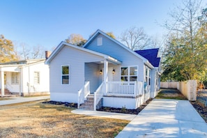 A single-story house with a front porch, a chimney, and a small front yard. - 3-bedroom house in beautiful Sumter with cool AC breeze (Sumter)