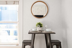 ☀️ Bright window dining table—bathed in soft daylight for casual breakfasts or laptop work. - The Penn Hotel - Queen Bed, AC & Gaslamp Nightlife! (San Diego)