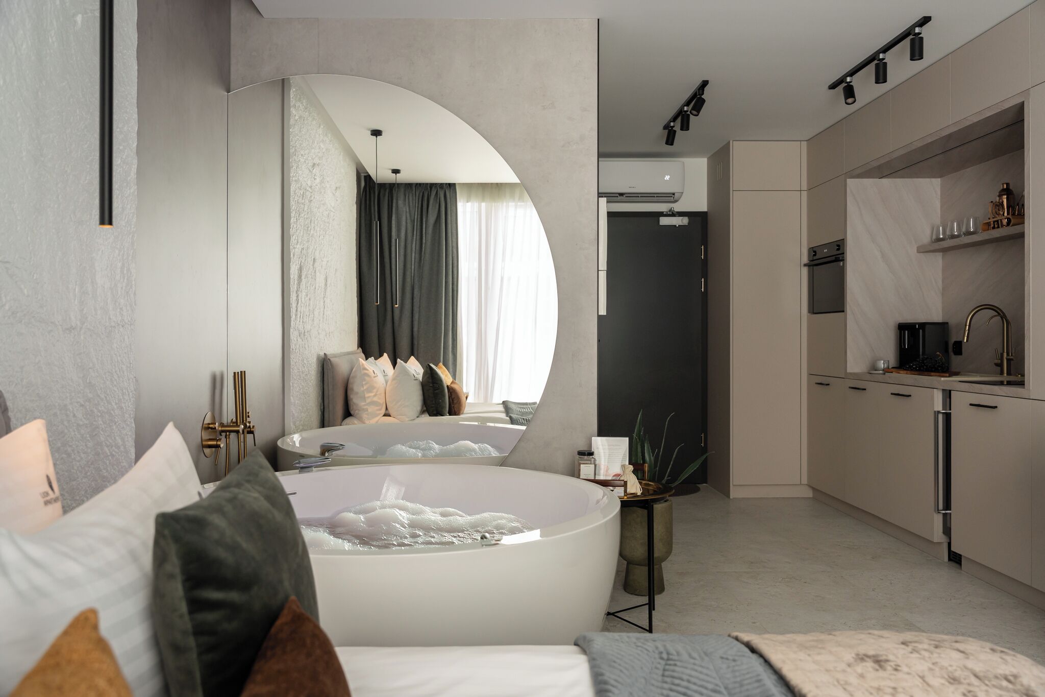 A modern bathroom with a freestanding bathtub, a vanity with a sink, and a shower area.