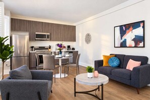 A modern apartment with a kitchen, dining area, and living room. - The Penn Hotel - 2BR Above Nightlife & Top Clubs!! (San Diego)