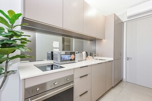 A modern kitchen with a built-in microwave, oven, and sink. - Refined City Living with Panoramic Views (Johannesburg)