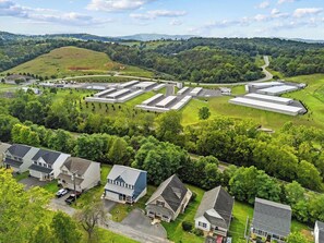 A residential area with detached houses, a large industrial complex, and a highway in the background. - Staunton Stay, Historic Charm & Modern Comfort (Staunton)