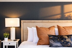💤 Warm bedroom suite detail—featuring leather accent pillows, bedside reading lamp, and hotel-grade mattress. - The Penn Hotel - Smart TV, King Bed & Walkability! (San Diego)