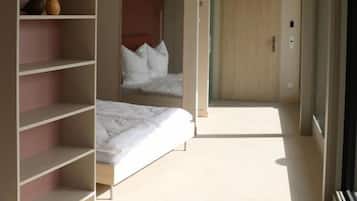Een slaapkamer met een bed, een kledingkast en een spiegel.
