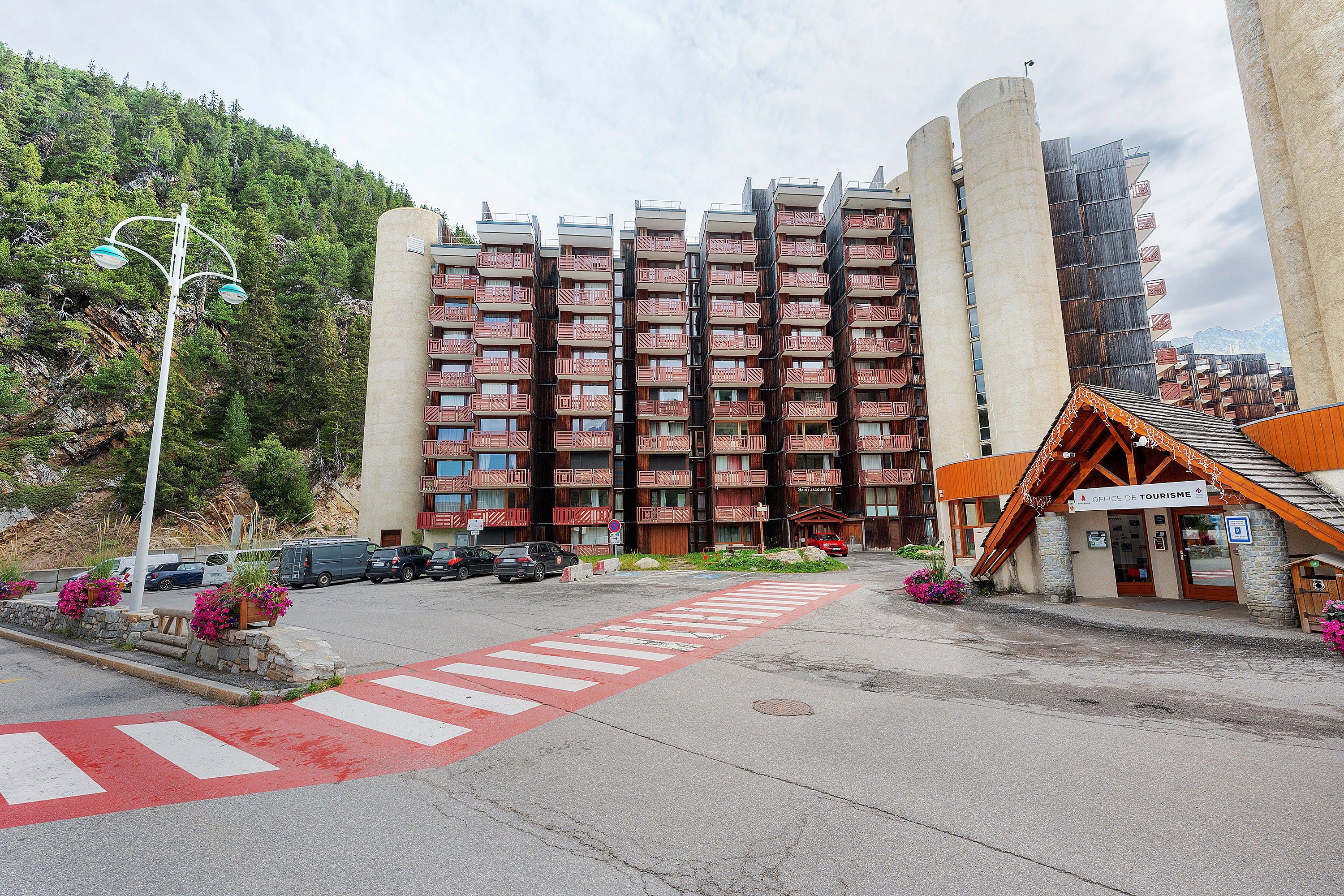 A multi-story hotel with a modern design, featuring balconies and a prominent entrance.