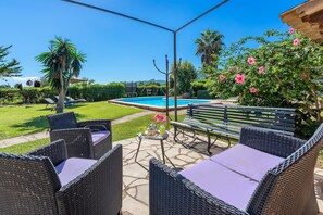 An outdoor seating area with wicker furniture, a pool, and a view of the landscape. - Pollensa Country Villa for 6 (Pollensa / Pollença)