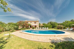 A swimming pool with lounge chairs, a stone house, and a well-maintained garden. - Scenic Country Haven with Pool (Pollensa / Pollença)