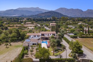 A residential property with a swimming pool, surrounded by greenery and hills in the background. - Grand Majorcan Retreat with Pool (Pollensa / Pollença)