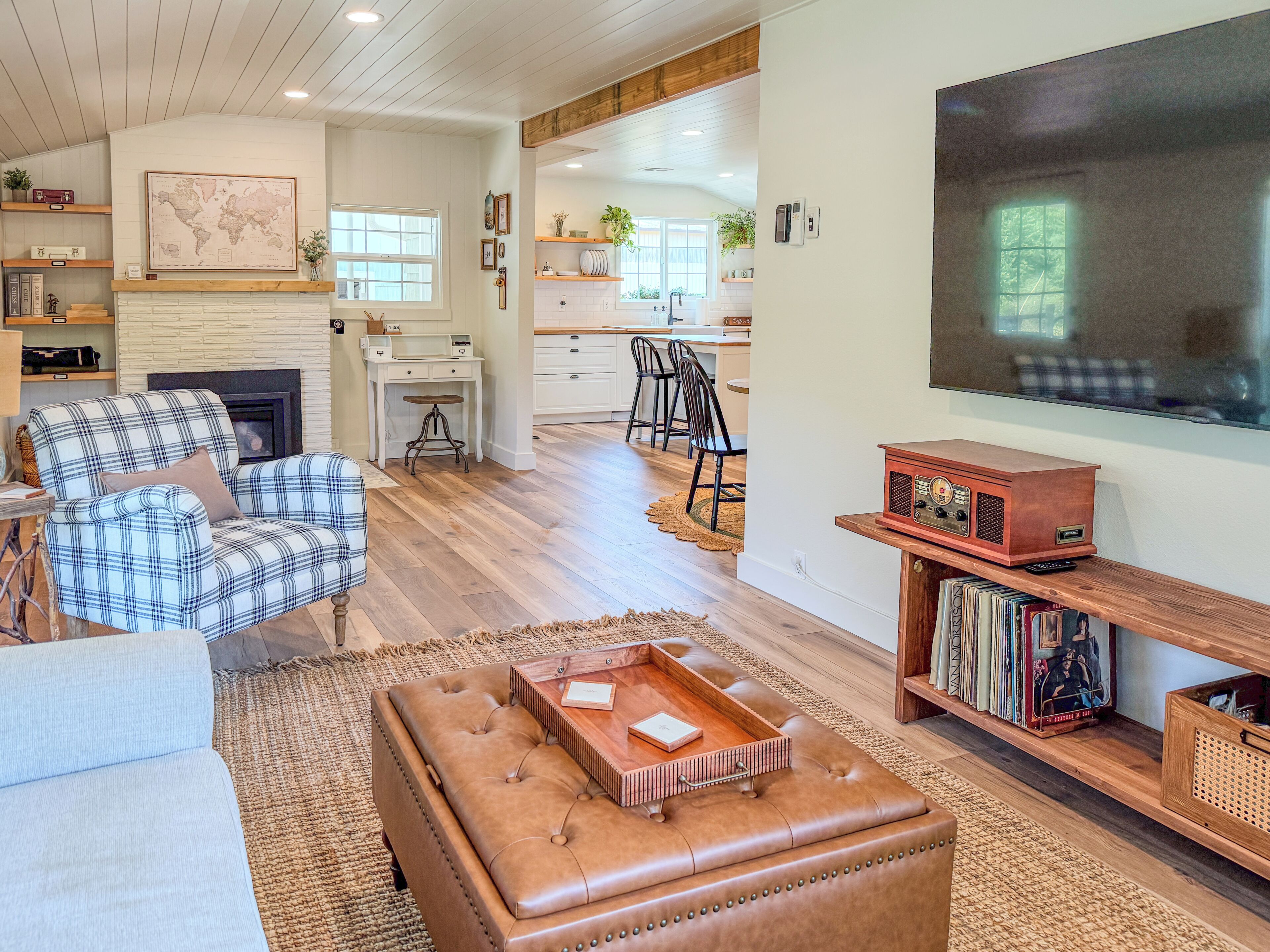 A living room with a fireplace, a television, and a bookshelf.