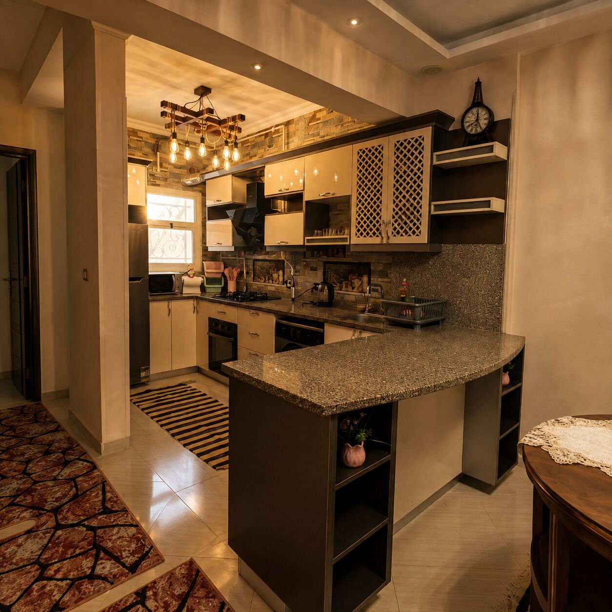 A modern kitchen with granite countertops, stainless steel appliances, and a built-in oven.