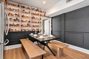🍴 Bench-style dining beside a wall of curated décor—an easy spot for meals with friends or family. - The Penn Hotel - Party in Gaslamp! Chic 2BR for 6! (San Diego)