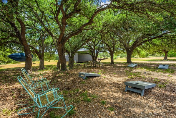 A park with picnic tables, a hammock, and a small shelter.