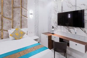 A modern hotel room with a bed, a desk, a chair, a television, and a marble wall.