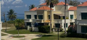 A multi-story hotel with balconies, a pool area, and a view of the ocean. - Villa del Sol - Oceanfront Rincon Retreat w Pool (Rincon)