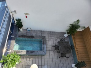 A rooftop pool area with a tiled floor, a small pool, and surrounding seating. - seombadi hotel (Ulleung)