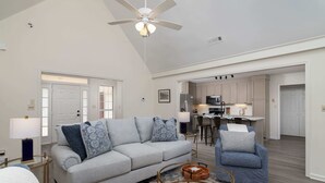 A living room with a grey sofa, two armchairs, a coffee table, and a ceiling fan. - Tanner Drive Getaway | Pet Friendly (Oxford)