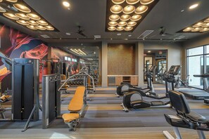 A gym with various exercise equipment, including treadmills and weight machines. - Landing Amazing 2bd, Gym (Glendale)