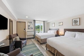A hotel room with two beds, a desk, a chair, a flat-screen TV, and artwork on the walls. - Central Studio~9 Min drive 2 FALLS+Clifton Hill! (Niagara Falls)