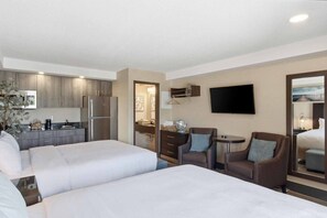 A hotel room with two beds, a kitchenette, a TV, and a seating area with a table and chairs. - Serene Studio w. 2 Beds, FREE Parking&9Min 2 Falls (Niagara Falls)